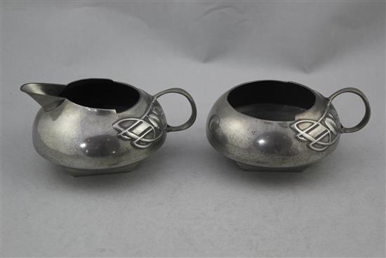 A Liberty Tudric pewter three piece tea set, no.0231, designed by Archibald Knox, teapot 9.75in.